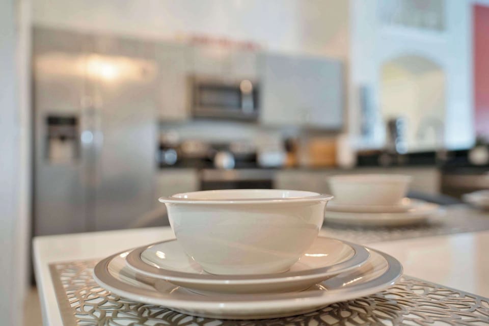 Modern kitchen with a set table featuring white dishware for a welcoming dining experience.