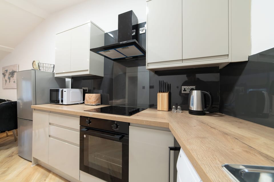 A spacious open-plan kitchen equipped with modern appliances and a washing machine—perfect for longer stays.