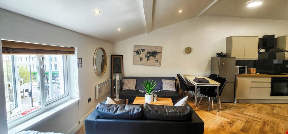 The open-plan living space features two double beds, making it ideal for couples or small groups, with plenty of comfortable seating for relaxing or socialising and views of Liverpool’s iconic Bombed Out Church.

