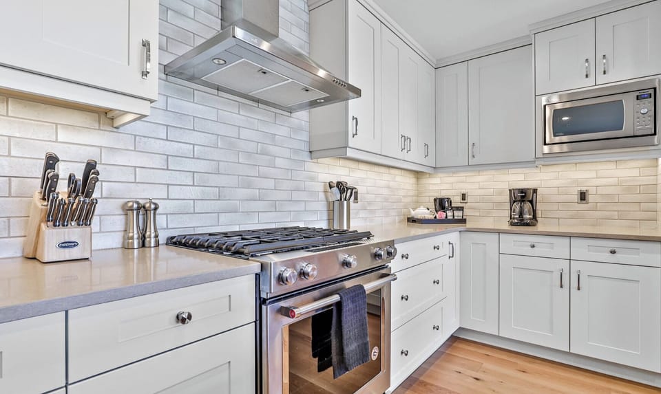Fully stocked gourmet kitchen! High end stainless steel appliances and natural gas stove