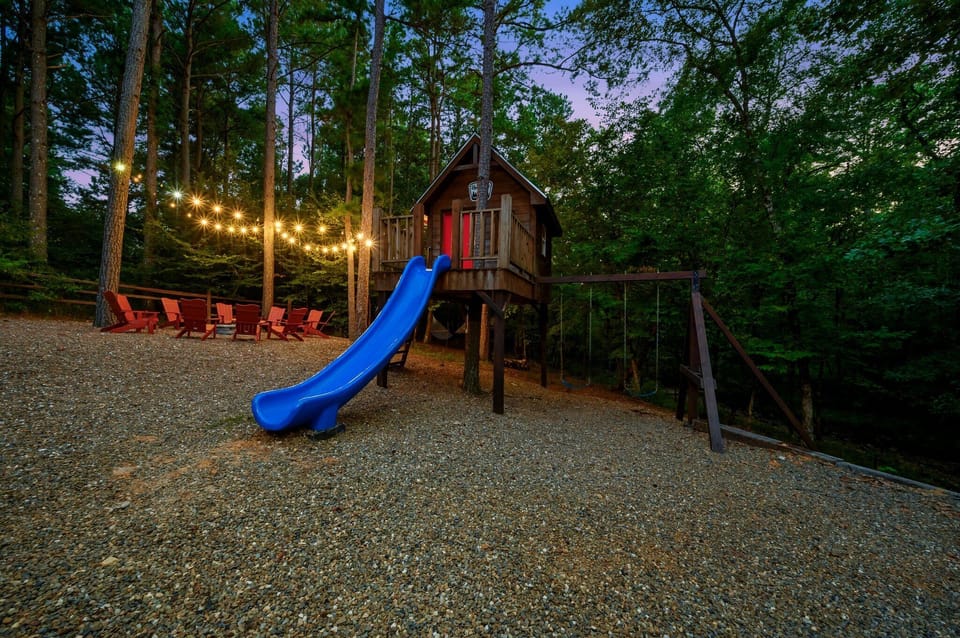 Treehouse has a front porch, swing set and slide. A/C and electricity inside