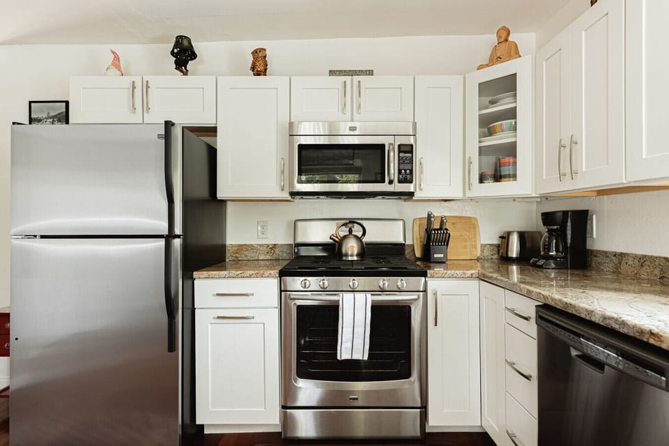 Open concept kitchen featuring drip coffee maker.