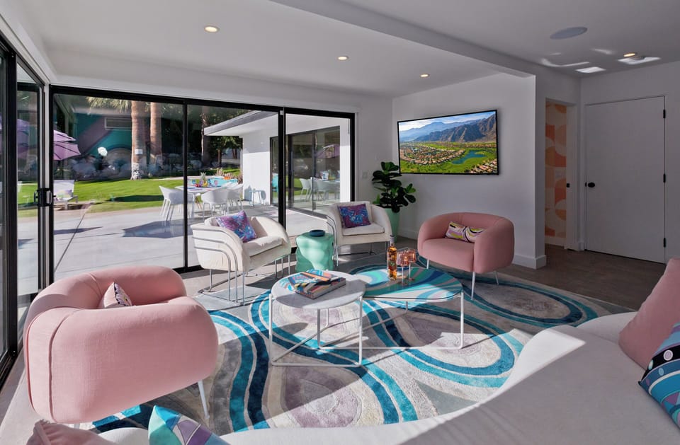 Living room with direct access to the pool deck. Large flat screen smart TV.