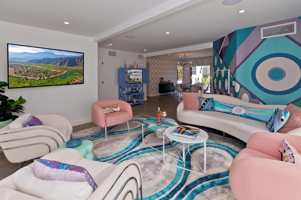 Living room with direct access to the pool deck. Large flat screen smart TV.