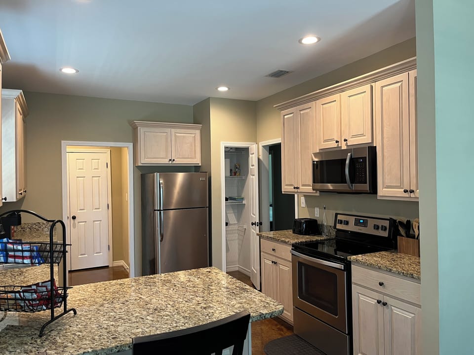 Kitchen has granite countertops, pots & pans, cooking utensils & dishwasher 