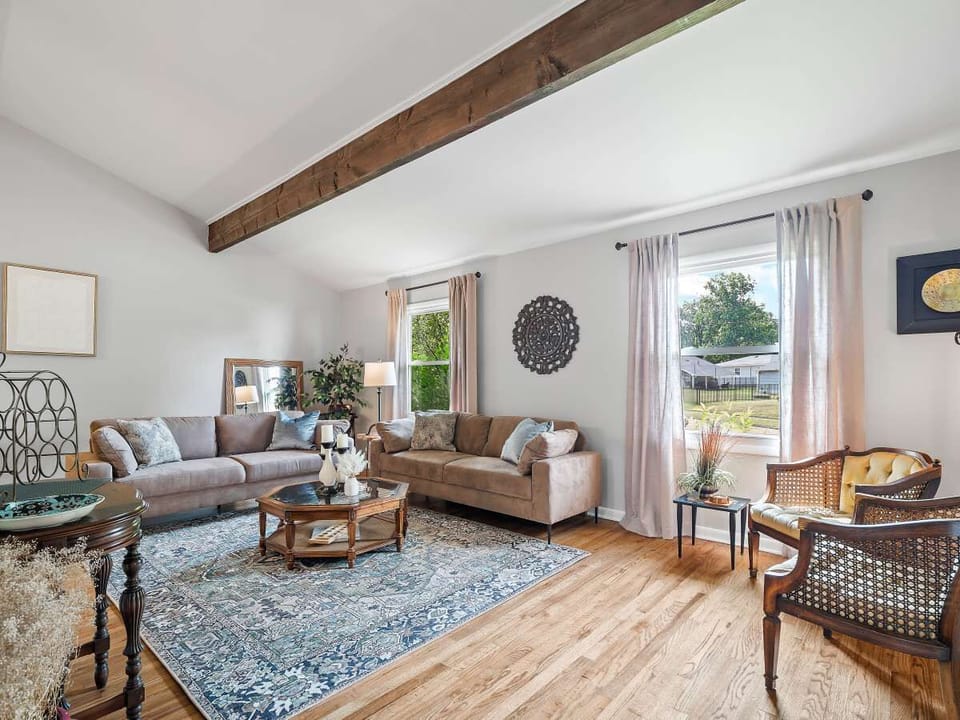 Cozy vibes and wooden highs! This living room is a dream come true with those stunning beams above and hardwood beneath.  #HomeSweetHome