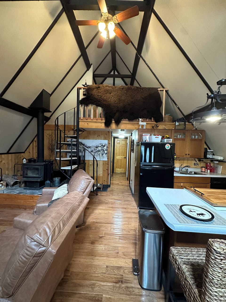 Main floor kitchen/dining/living room with wood burning stove