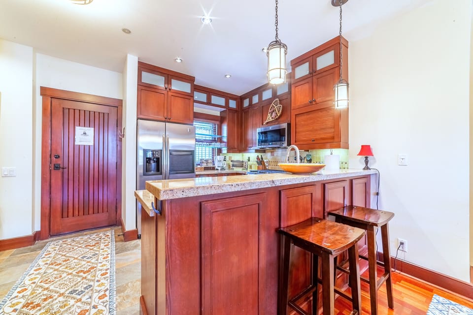 Bar seating in kitchen. Access to back patio with private seating area and jacuzzi.