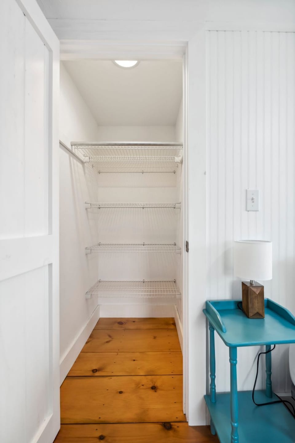 Bedroom #2 with full bed, smart TV, and small closet and dresser for clothing storage