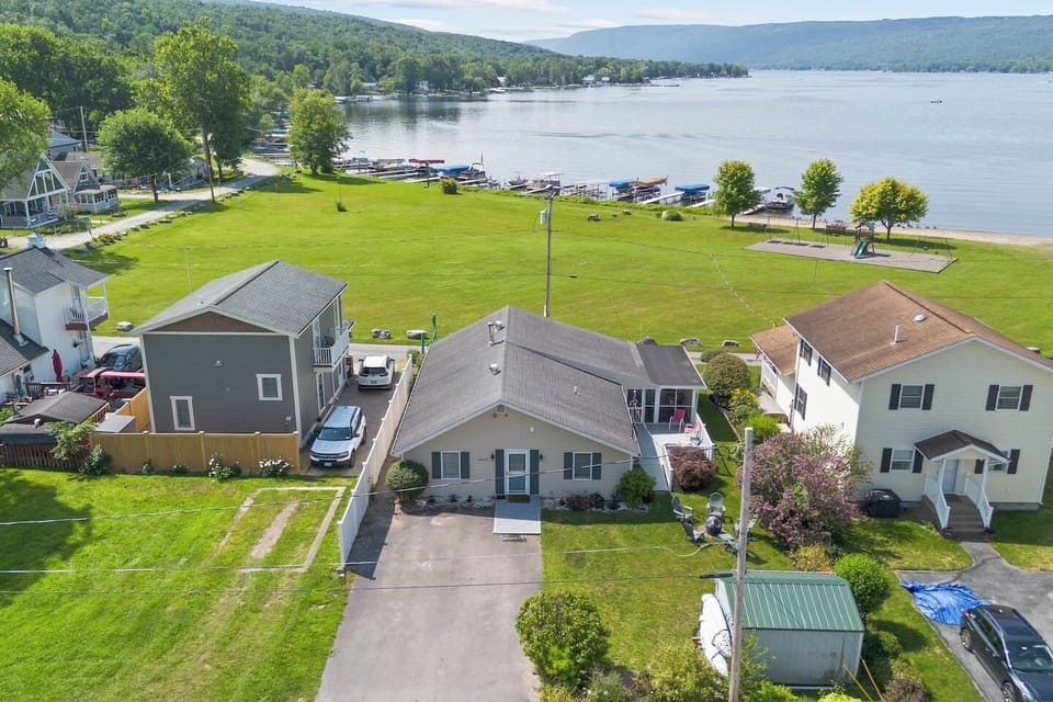 Charming lakeside retreat with ample green space and easy access to Honeoye Lake. Ideal for family gatherings and outdoor fun. 