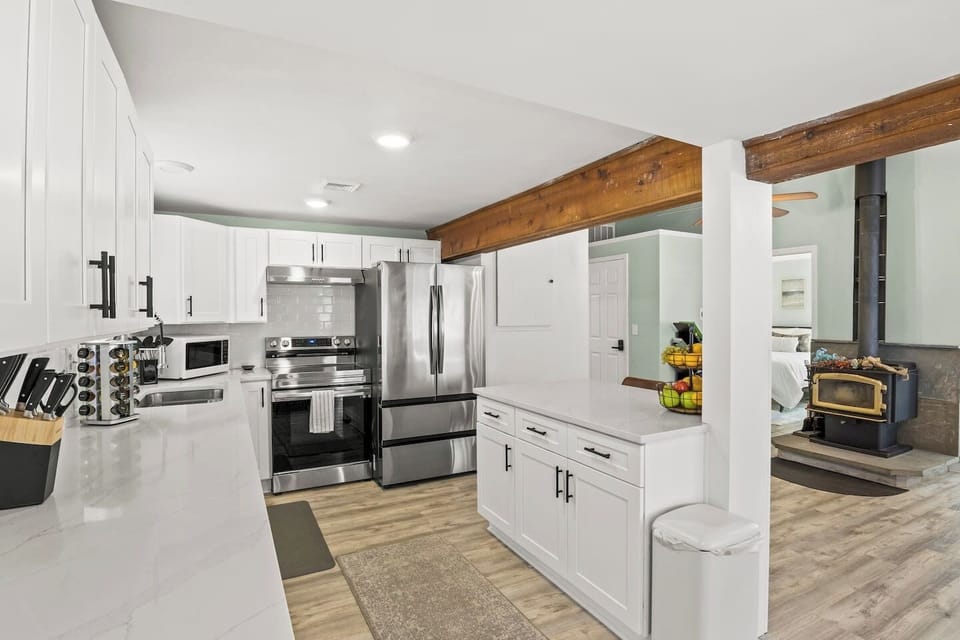 Modern kitchen with stainless steel appliances and ample counter space, perfect for preparing meals during your stay in Honeoye, NY. 