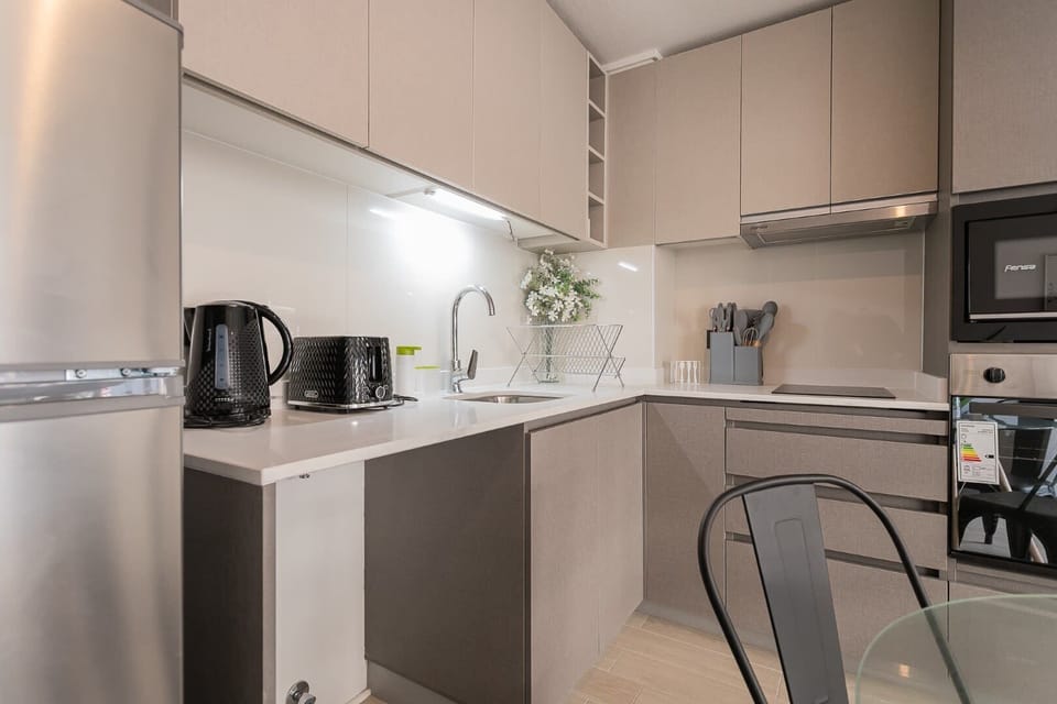 Modern kitchen with sleek appliances and stylish design, perfect for culinary enthusiasts.