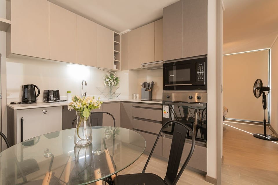 Enjoy cooking in this sleek, modern kitchen with all the essentials and a cozy dining area.