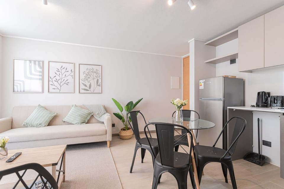 Modern studio with stylish decor, cozy seating, and a compact kitchen—ideal for a relaxing stay in Chile.