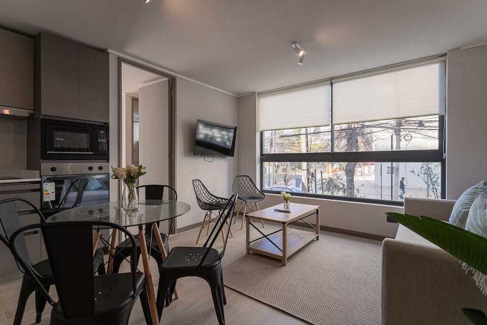 Bright and stylish living area with modern furnishings and large windows for a relaxing stay.