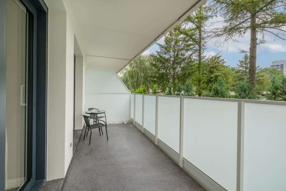 The balcony's stylish design complements the apartment's decor. 