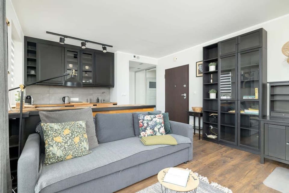 A grey sofa bed with a coffee table beside it. 