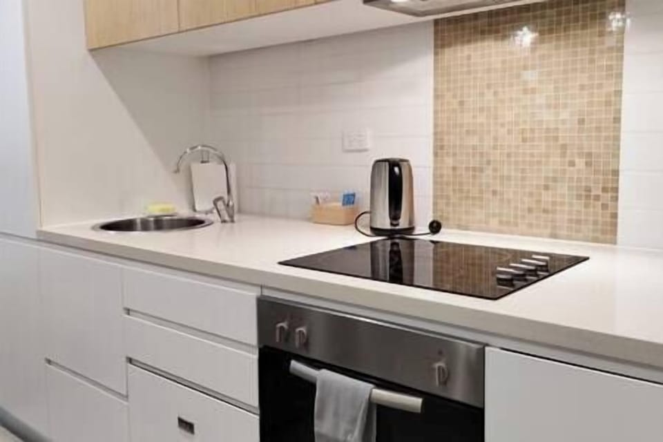 Kitchen, with bar fridge, oven, dish washer and microwave