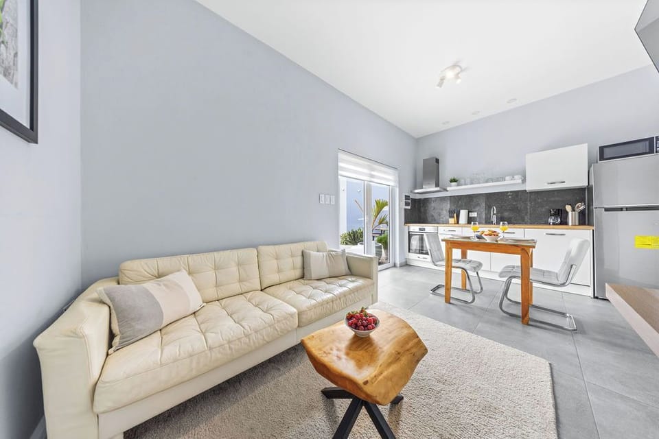 Relax in our cozy living room featuring a comfy sofa, refreshing air conditioning, and your favorite shows on the flat-screen TV.
