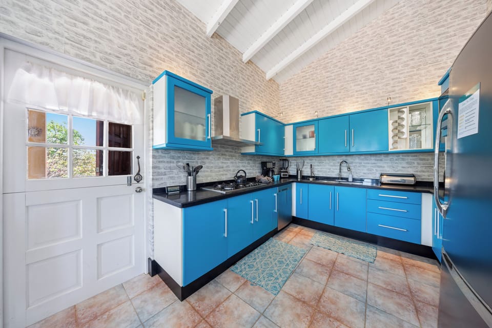 A spacious, well-lit kitchen featuring all the essentials for preparing meals during your stay.