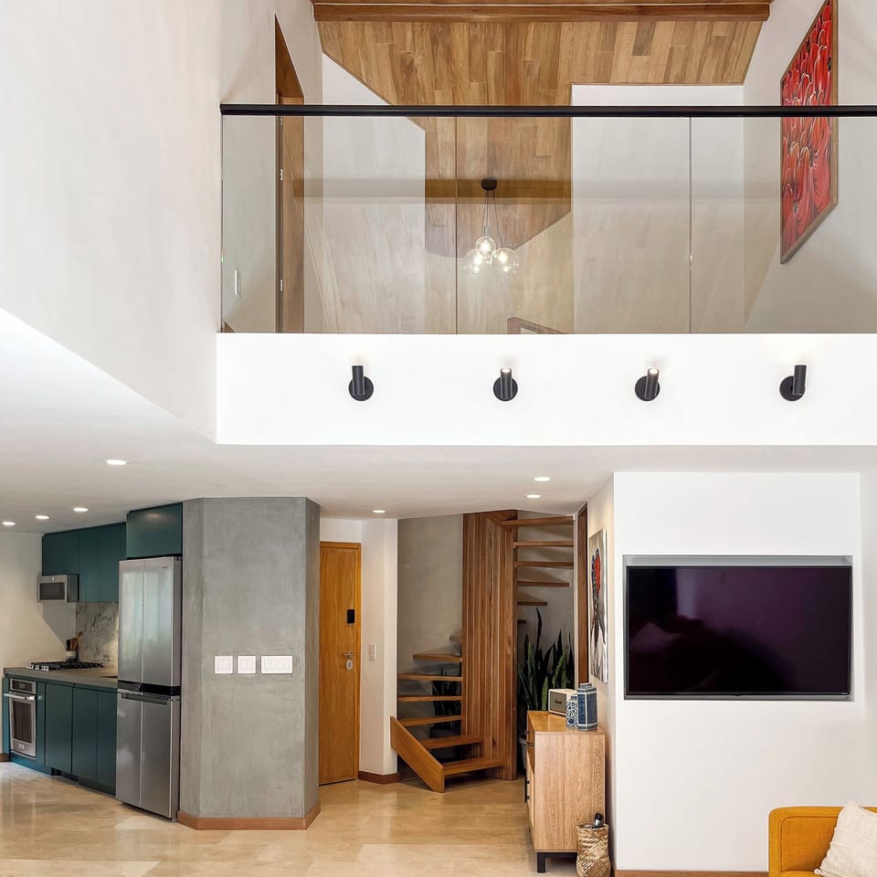The living room has 2-story, oak ceilings that look onto the 2nd-floor landing
