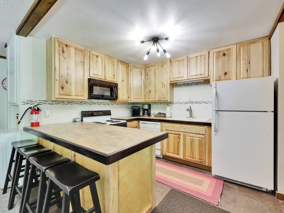 View of Kitchen with Counter Seating for 4, Electric Oven/Stove, Microwave, Dishwasher & Refrigerator