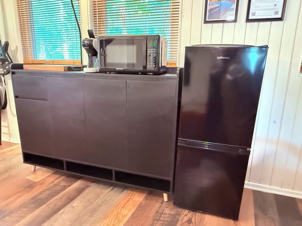 Breakfast and snack area with microwave, fridge, and kettle for your convenience