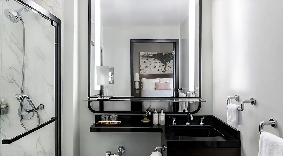 Refresh with a bright marble shower and spa-like vanity.