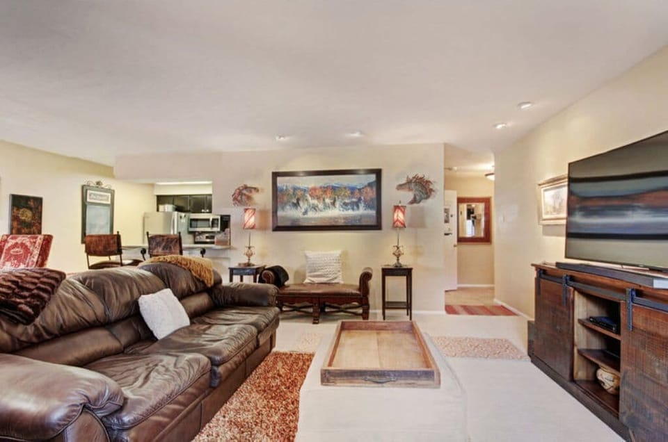 Enjoy quality time in the additional living area, offering ample seating, a large flat-screen TV, and tasteful decor that makes it a perfect spot for entertaining guests or enjoying a quiet evening.