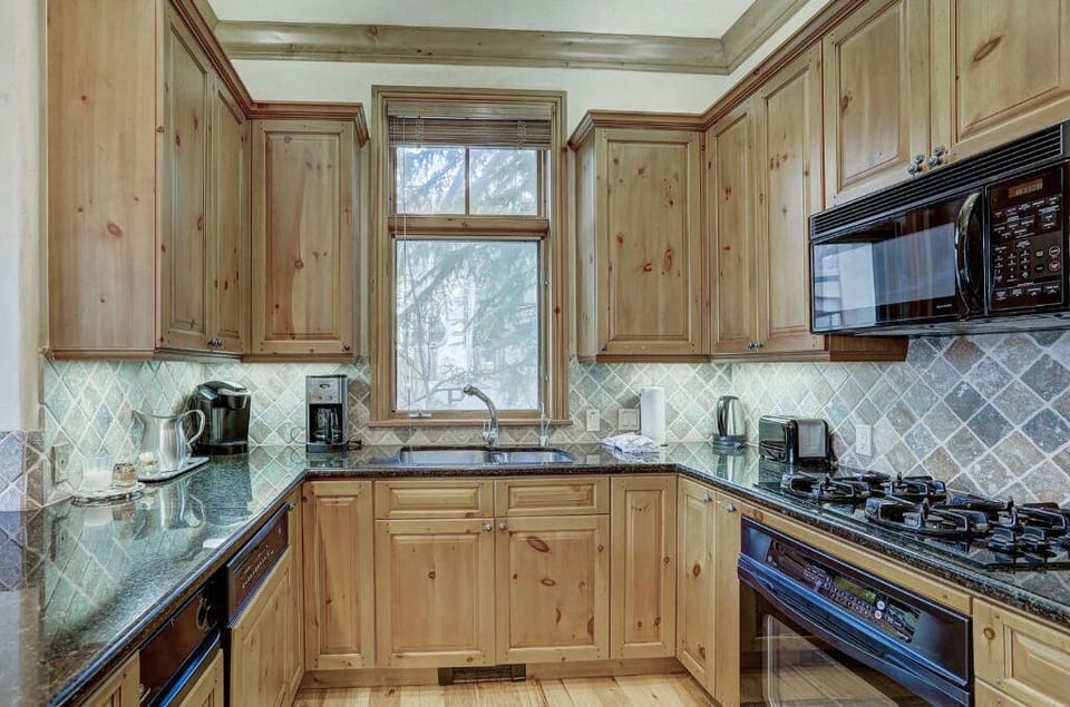 Cook up delicious meals in the modern kitchen, featuring stainless steel appliances, granite countertops, and plenty of cabinet space.