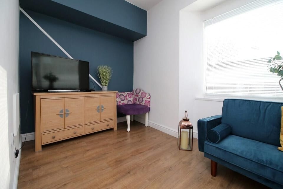 Whether you're catching up on work, spending a quiet evening in, or sharing the space with a loved one, the relaxed atmosphere and stylish touches make this living area a truly welcoming spot.