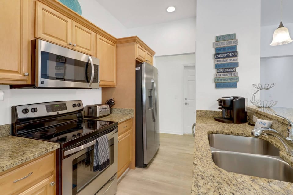 The kitchen is well equipped with full size oven, microwave, refrigerator/freezer and dishwasher