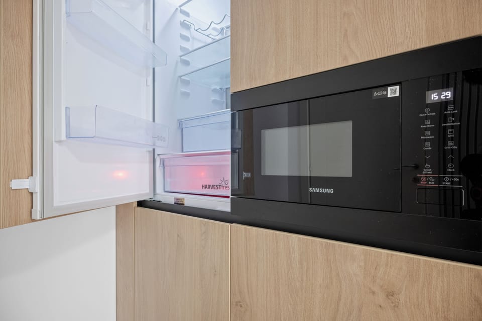 kitchen coffee tea water fridge microwave oven dining table 