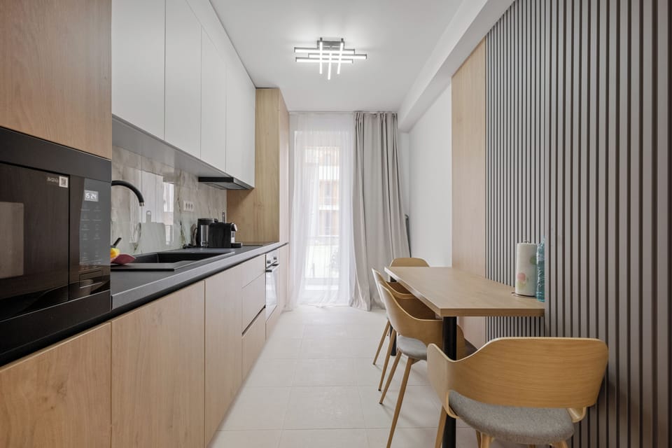 kitchen coffee tea water fridge microwave oven dining table 