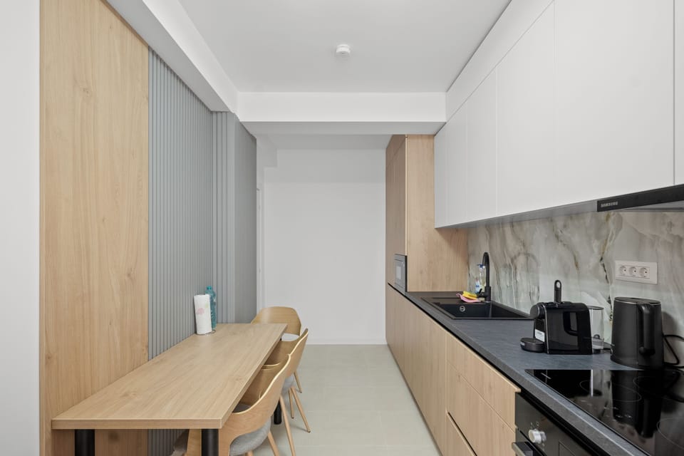 kitchen coffee tea water fridge microwave oven dining table 