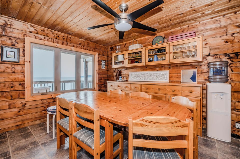 Gather around the spacious dining table with family and friends, enjoying delicious meals while soaking in the stunning lake view from the large window.