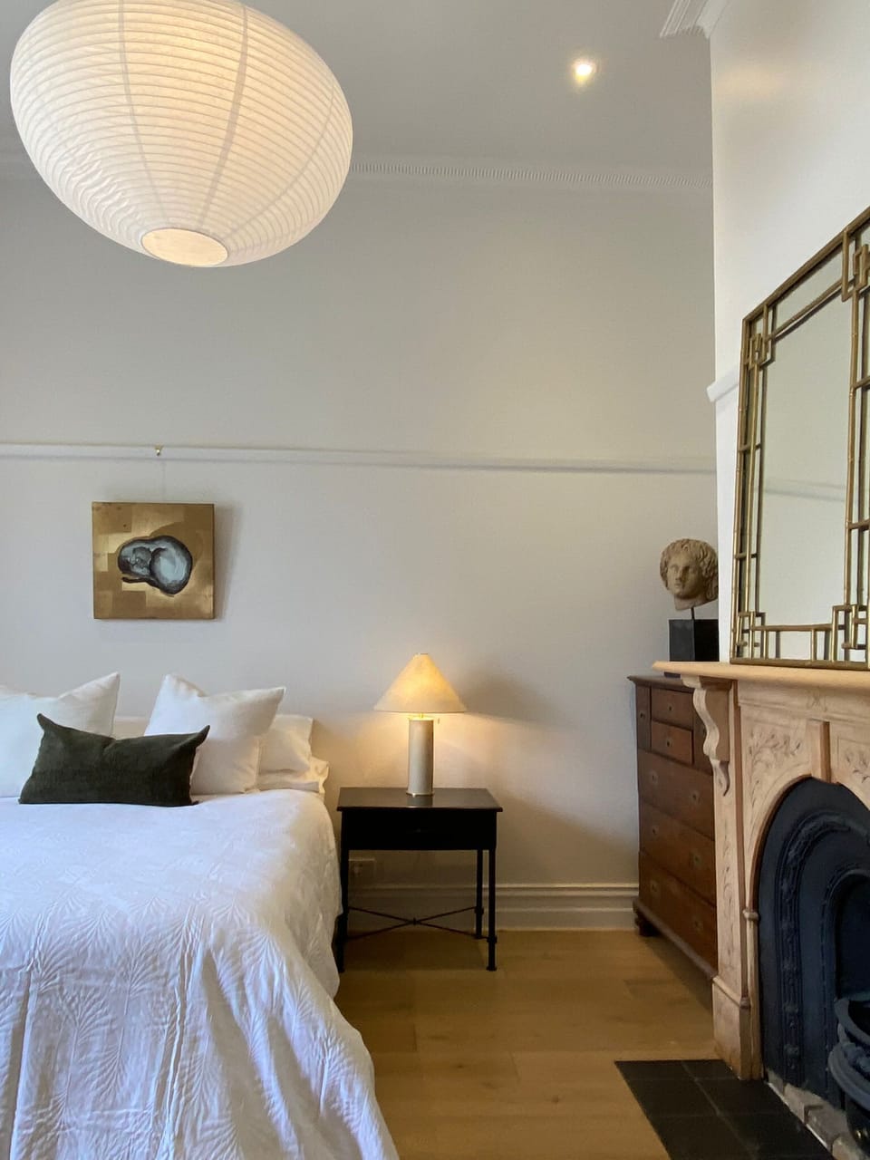 Bedroom with carefully selected furnishings and ornate fireplace