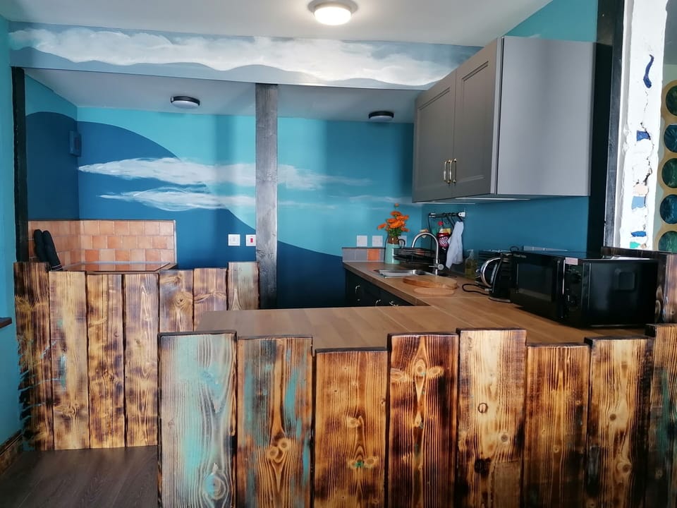 Hand oiled reclaimed wood surrounds the kitchen
