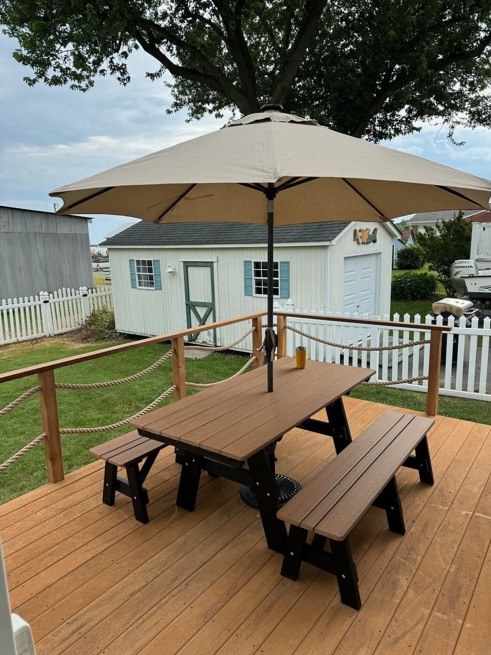 Deck with string lights and umbrella with solar lights. 