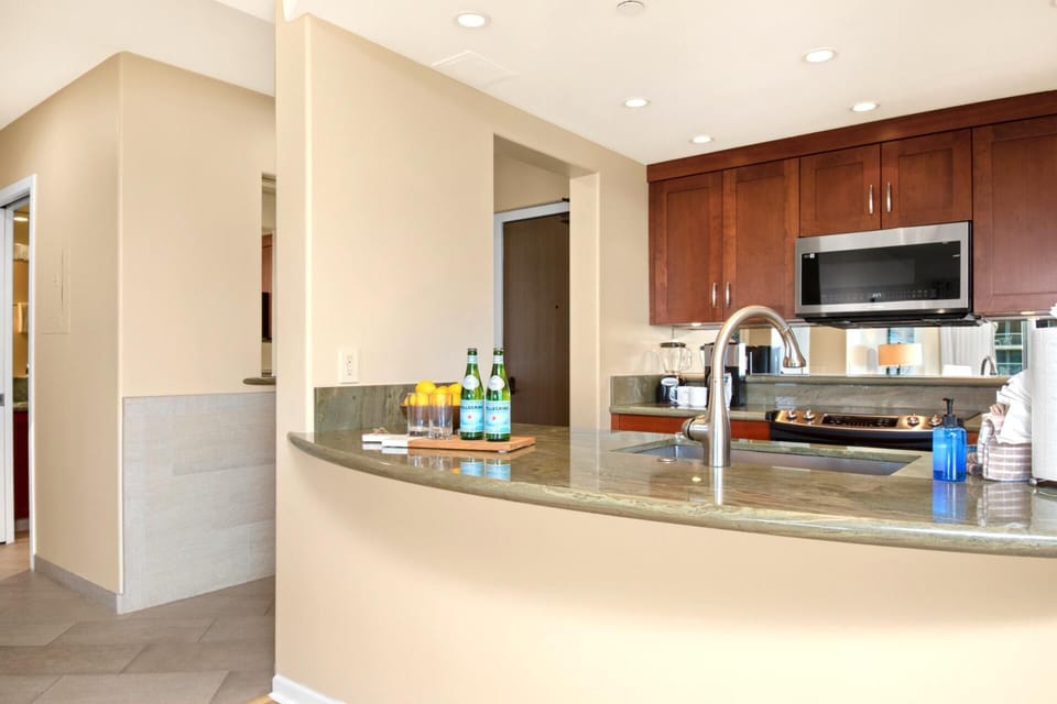 Cook and entertain with ease in this sleek kitchen featuring modern appliances and a spacious granite countertop. The open design keeps you connected to your guests while you prepare delicious meals in style.