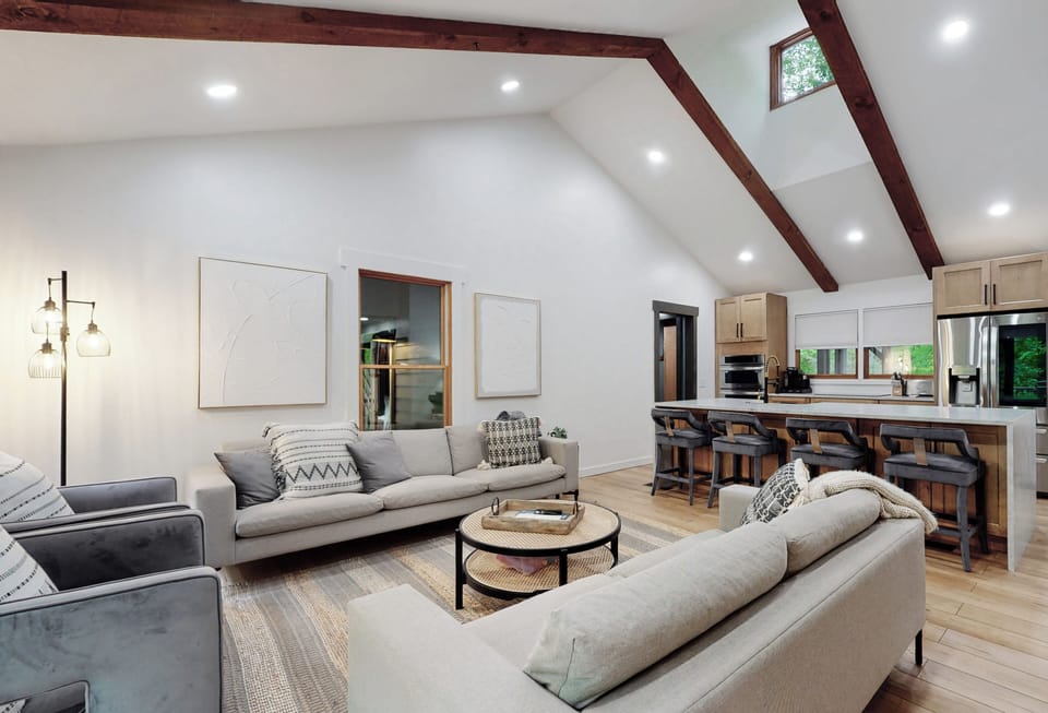 Open Living Room with TV and Gathering Area opens to main porches
