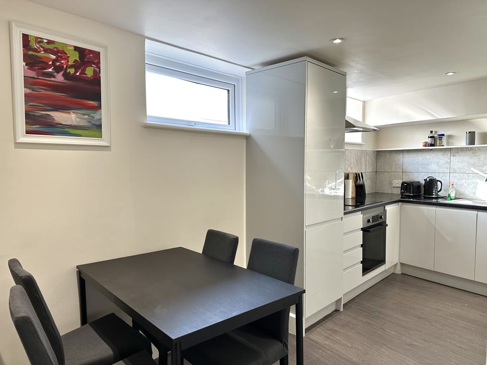 Lovely and light kitchen with original art by a Vogue featured artist and  all the pots, pans, utensils, crockery, plates, bowls, cutlery, appliances and space you need to cook a delicious meal for your stay! This kitchen is ready for you to cook in!