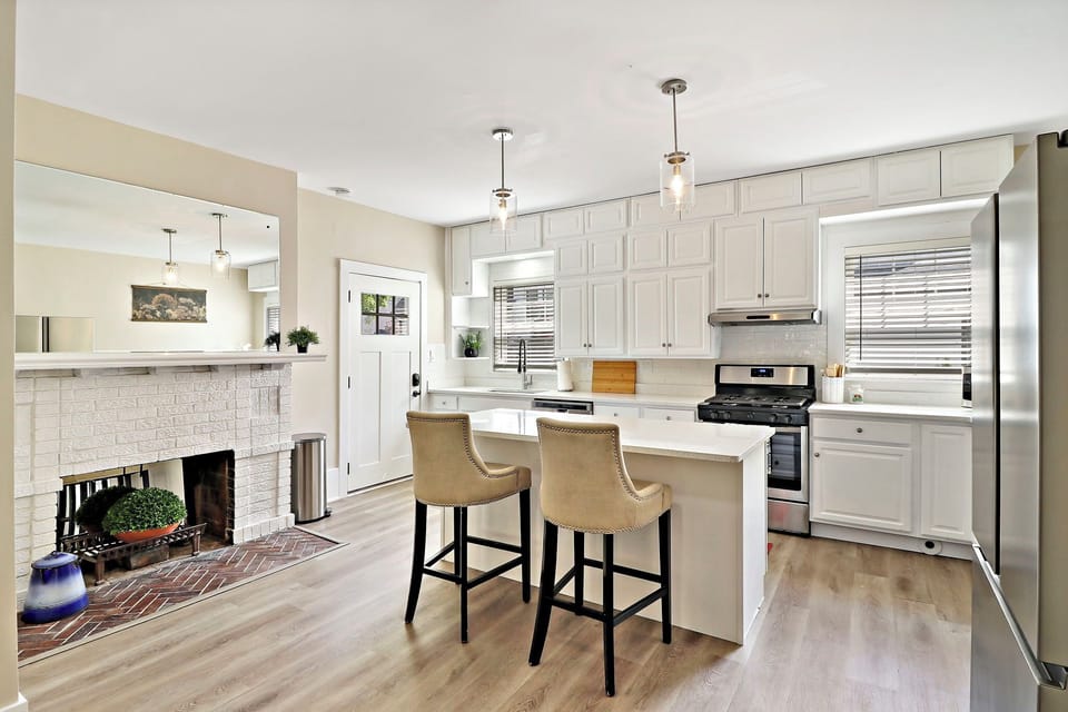 Open concept kitchen in lower unit includes breakfast bar