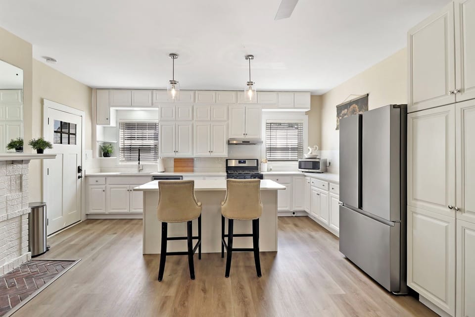 Open concept kitchen in lower unit includes breakfast bar