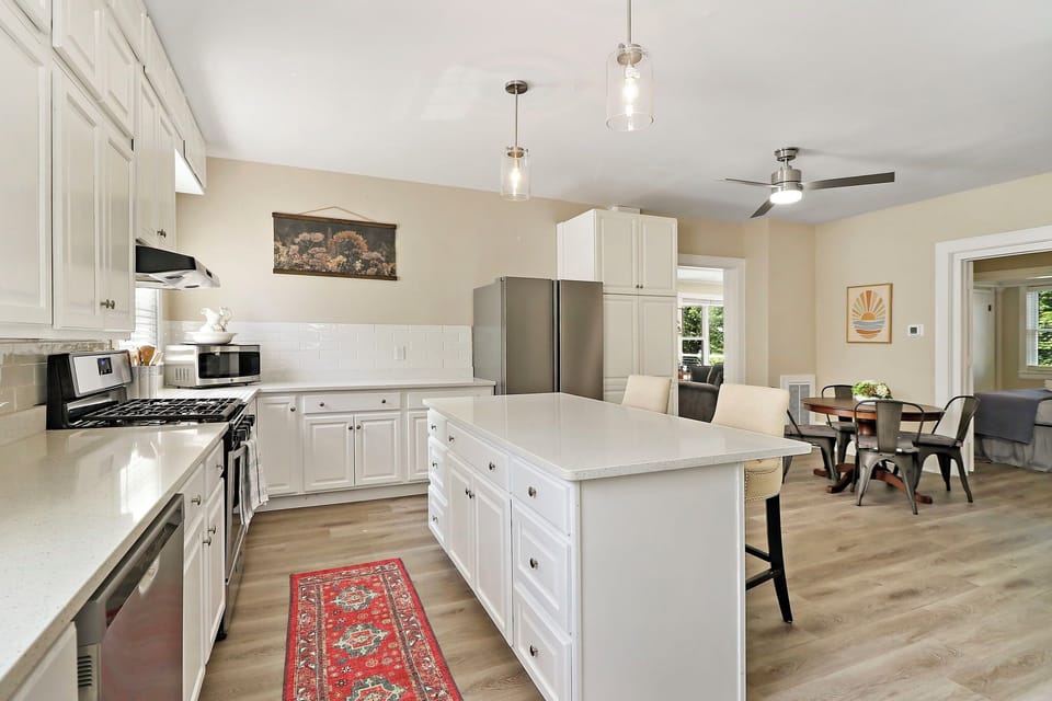 Open concept kitchen in lower unit includes breakfast bar
