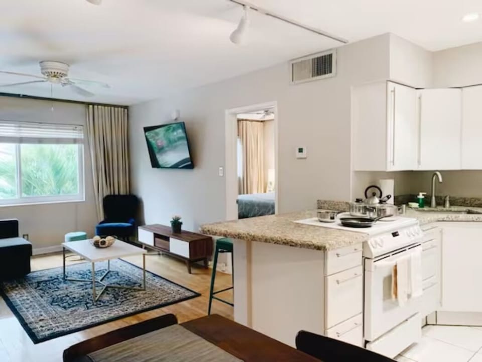 Step into seamless elegance where the living room meets the kitchen. A harmonious blend of style unfolds as plush comfort mingles with culinary inspiration, creating a space that invites shared moments and delightful connections