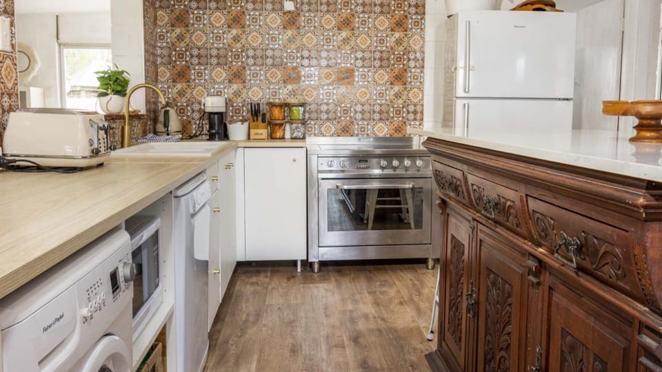 Plenty of bench top space with large kitchen island offering alternative dining 