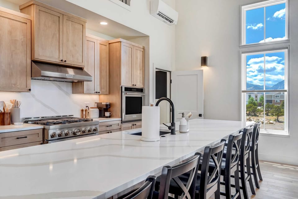 Step into our gourmet kitchen, featuring high-end appliances and a spacious island perfect for meal preparation and casual dining.