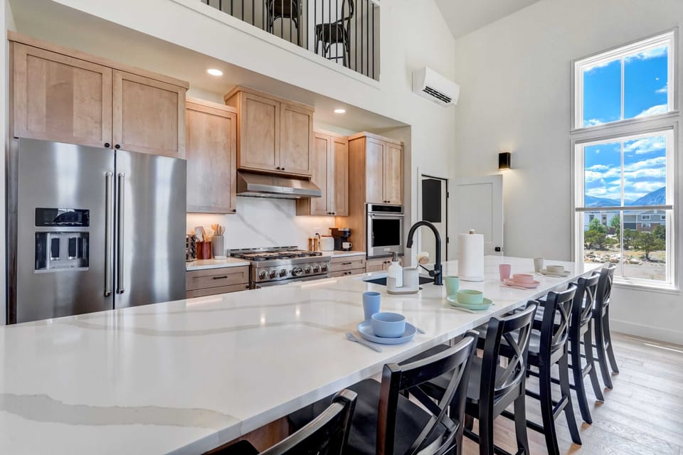Modern kitchen with high-end appliances, large island, and stunning views.