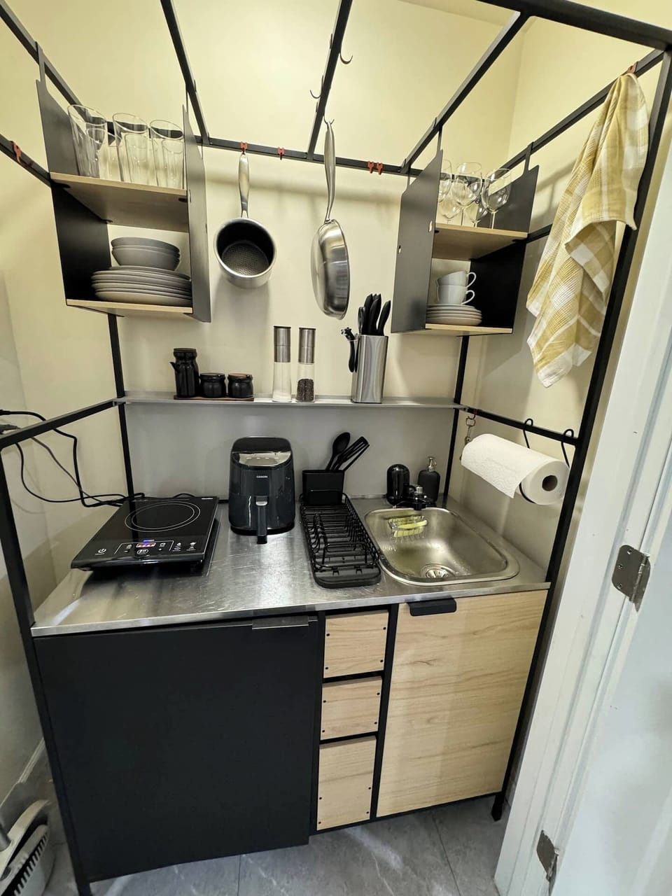 Fully equipped kitchenette with cookware, induction stove, air fryer, and essentials.
